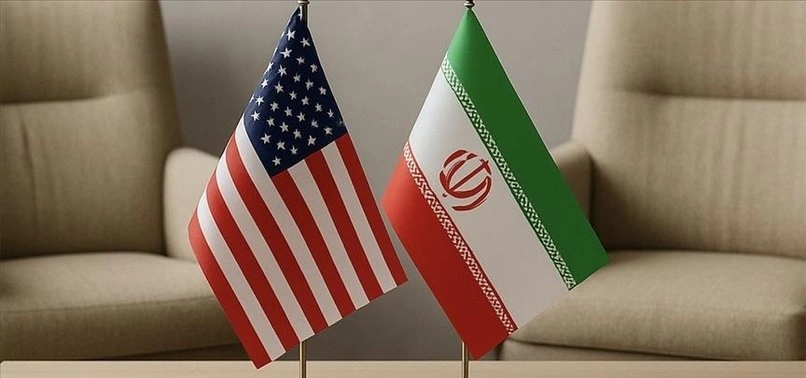 Flags of the United States and Iran displayed side by side on stands