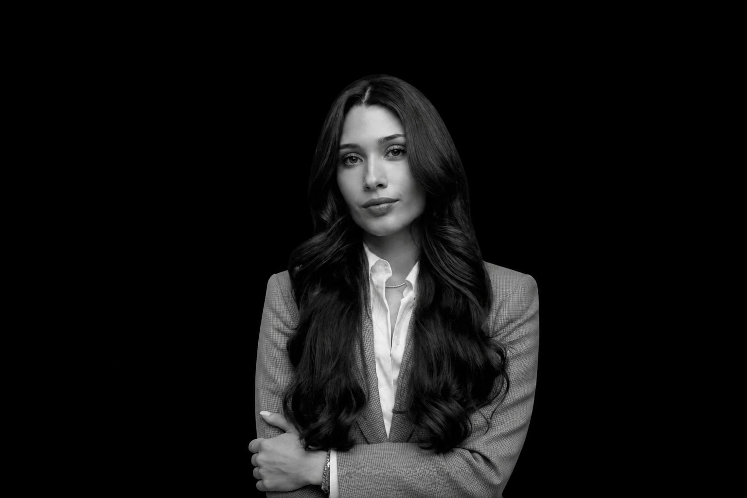 Portrait of Isabela Herrera with a blurred city skyline in the background