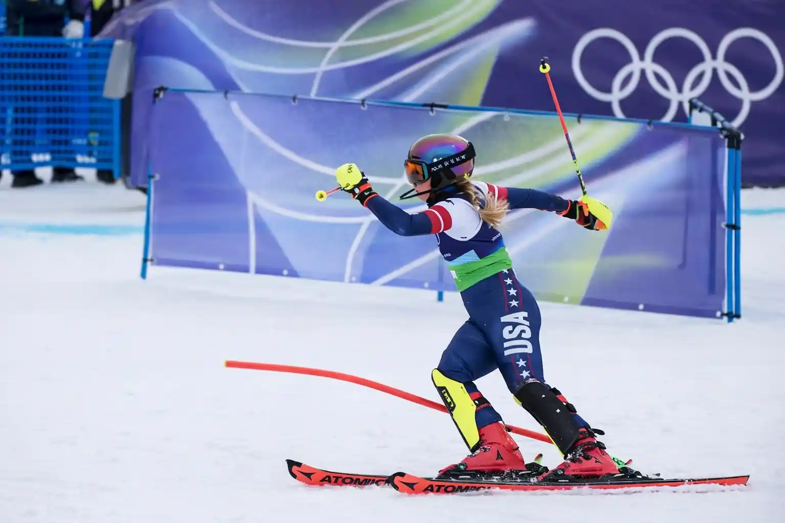 Mikaela Shiffrin skiing through a gate during the slalom portion of the team combined event at the Cortina Olympics.