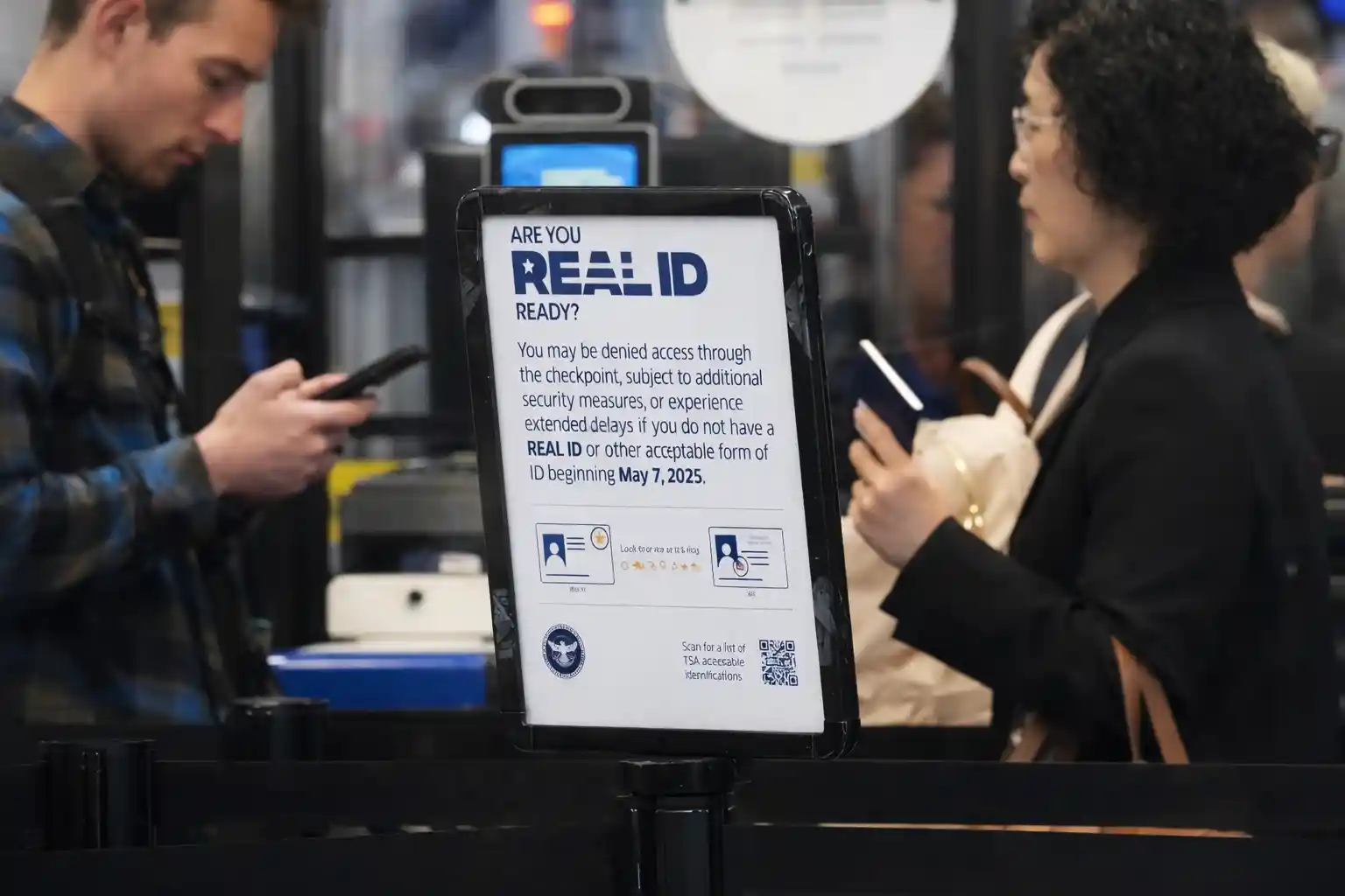Airport checkpoint sign warning travelers about REAL ID requirements and compliance deadlines