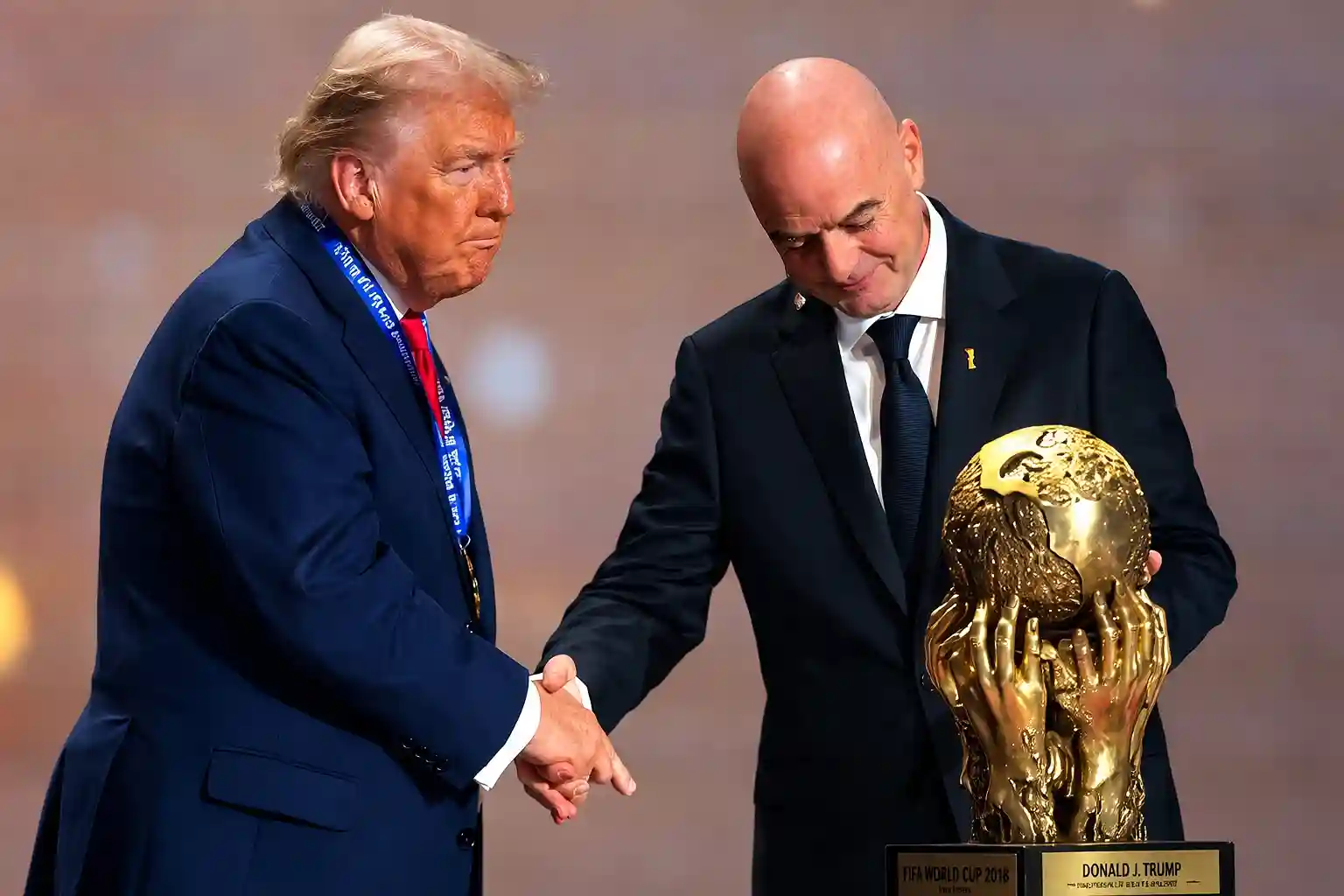 Officials greeting each other at global sports event while holding a golden football tournament trophy