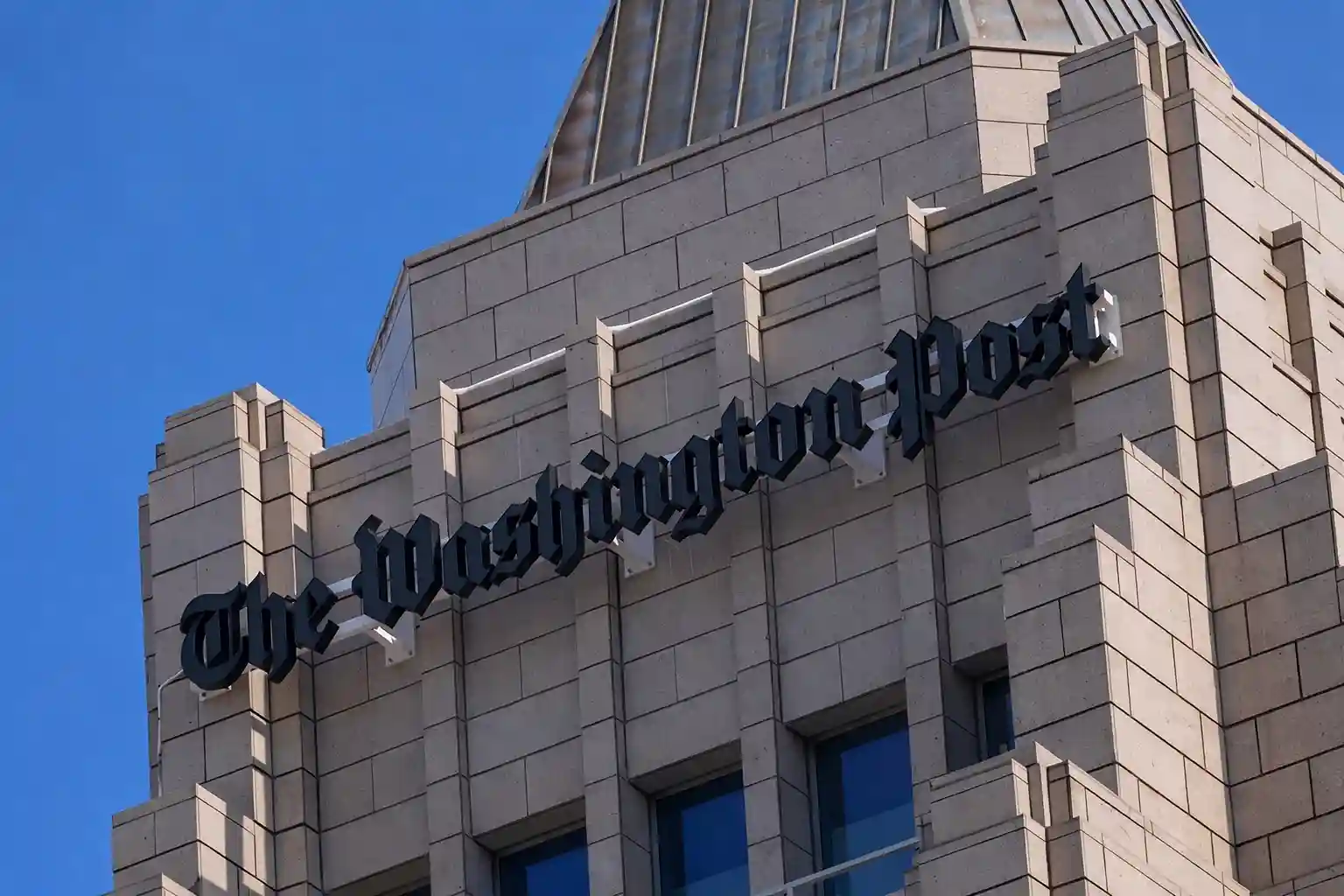 The Washington Post building exterior with the newspaper’s name displayed on the facade
